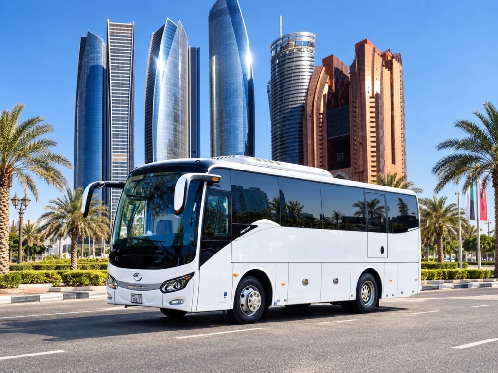 White luxury coach with Abu Dhabi towers; King Long branding