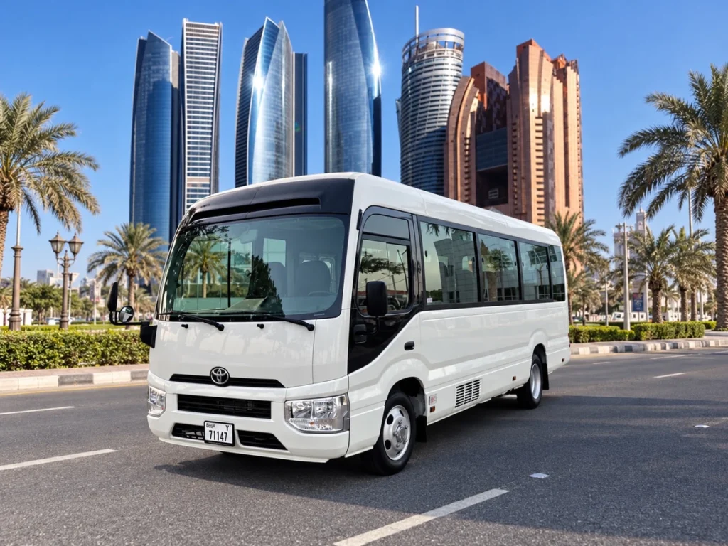 White Toyota mid-size bus with Abu Dhabi towers